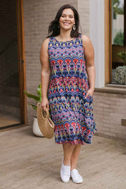Model Lauren wearing size 16 of the Belle Aztec Trapeze Dress in colour Aztec (Red), from the front, showing the whole outfit
