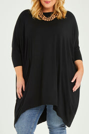 Model Caitlin wearing size L of the Belle Essential Throw Over in colour Black (Black), from the front, cropped image