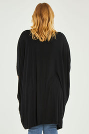 Model Caitlin wearing size L of the Belle Essential Throw Over in colour Black (Black), from the front, cropped image