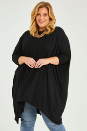 Model Caitlin wearing size L of the Belle Essential Throw Over in colour Black (Black), from the front, cropped image