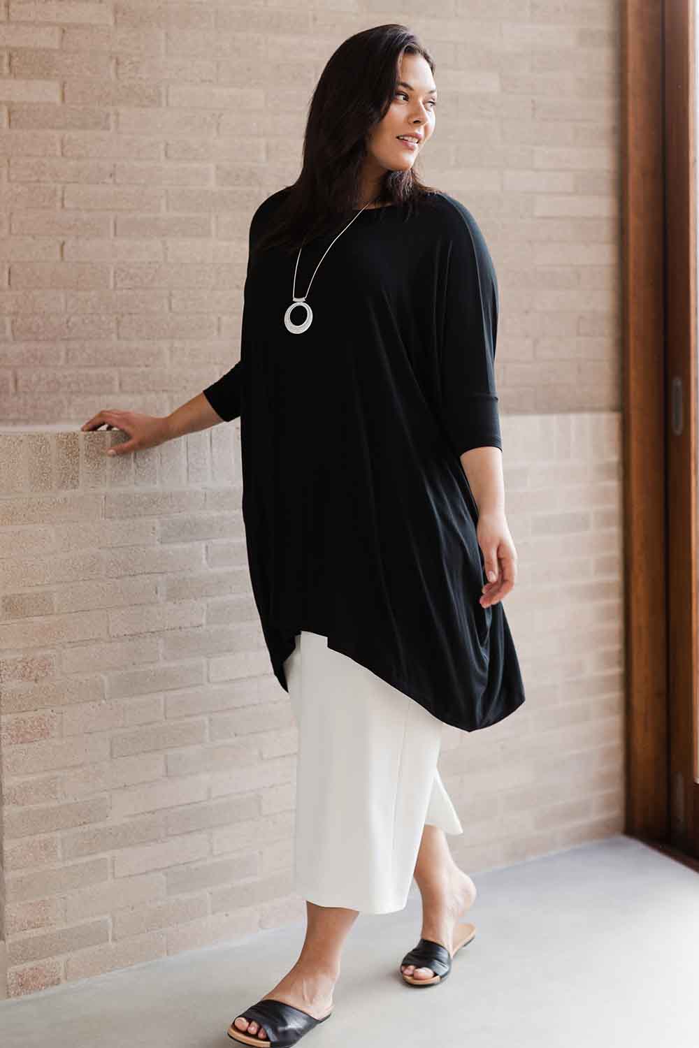 Model Lauren wearing size L of the Belle Essential Throw Over in colour Black (Black), from the front, showing the whole outfit