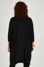 Model Maddy wearing size L of the Belle Essential Throw Over in colour Black (Black), from the back