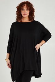 Model Maddy wearing size L of the Belle Essential Throw Over in colour Black (Black), from the front, cropped image