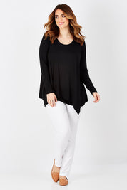 Model Laura wearing size 12 of the Belle Forgiver Tunic in colour Black (Black), from the front, showing the whole outfit