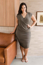 Model Lauren wearing size 16 of the Belle V Drape Dress in colour Khaki (Green), from the front, showing the whole outfit