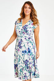 Model Laura wearing size 12 of the Belle Lavender Floral Wrap Dress in colour Lavender (Purple), from the front, cropped image