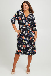 Model Monique wearing size 14 of the Belle Heather Floral Wrap Dress in colour Florals (Blue), from the front, showing the whole outfit