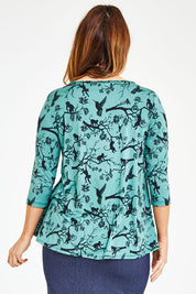 Model Laura wearing size 12 of the Belle Bird Printed Top in colour Bird (Green), from the back