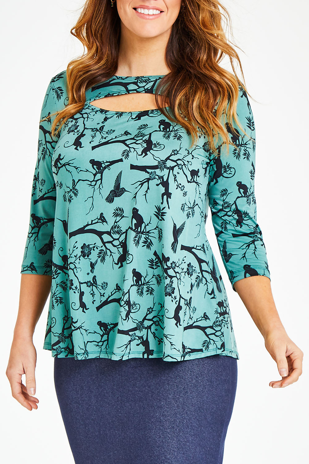 Model Laura wearing size 12 of the Belle Bird Printed Top in colour Bird (Green), from the front, cropped image