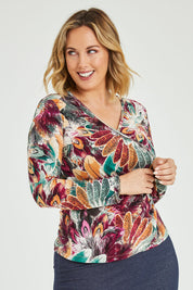 Model Jess wearing size 12 of the Belle Feathers Top in colour Feathers (Green), from the front, cropped image