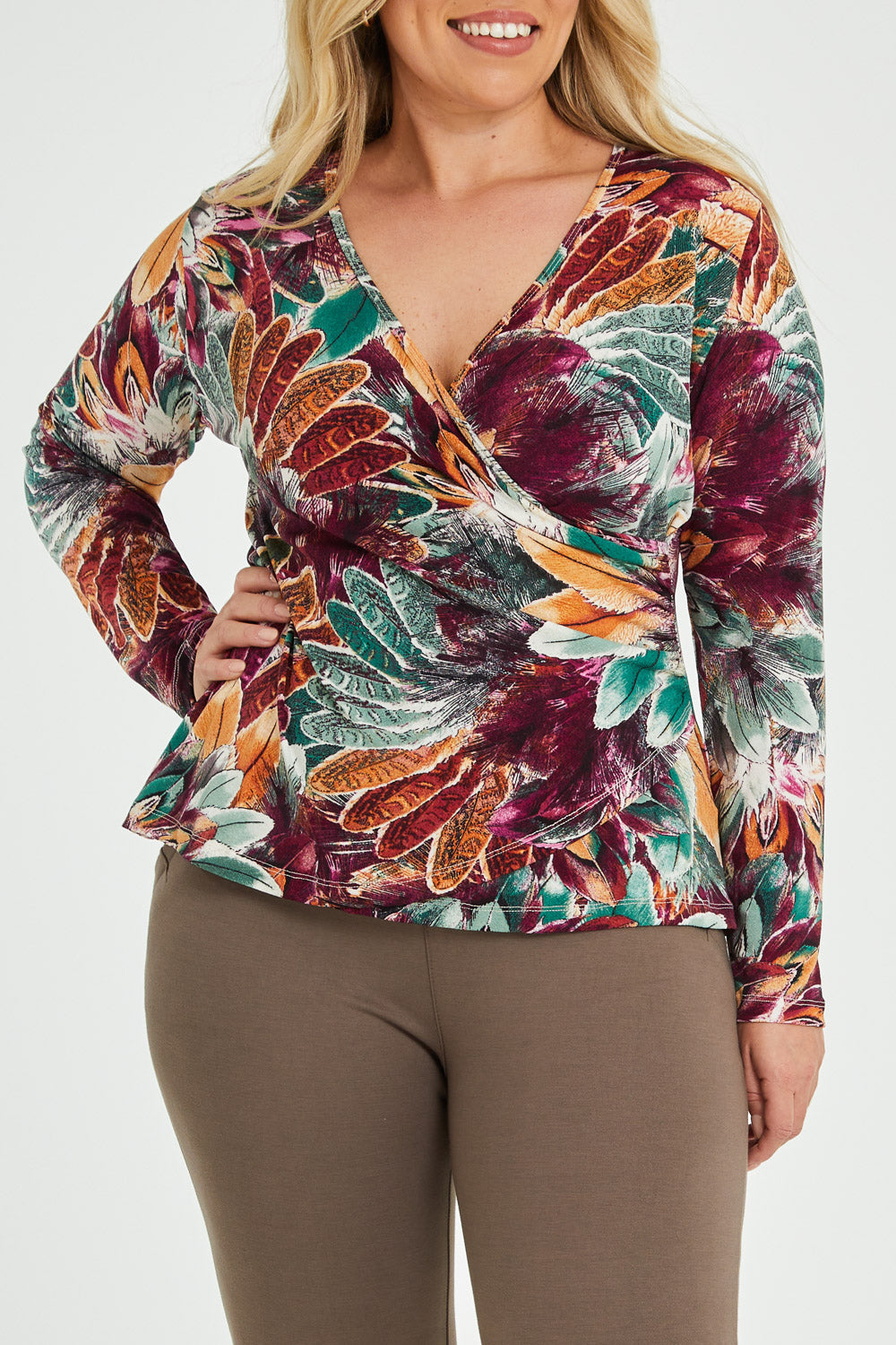 Model Katie wearing size 16 of the Belle Feathers Top in colour Feathers (Green), from the front, cropped image