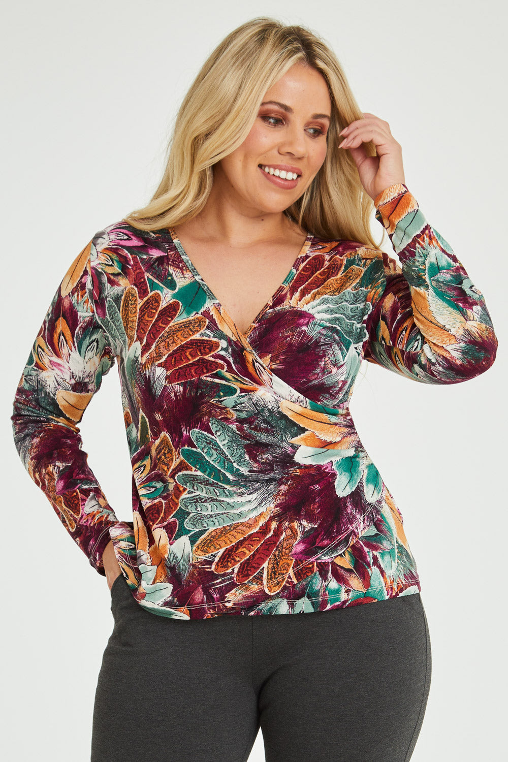 Model Katie wearing size 16 of the Belle Feathers Top in colour Feathers (Green), from the front, cropped image