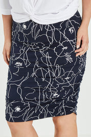 Model Jess wearing size 12 of the Belle Monoprint Side Gathers Skirt in colour Monoprint (Blue), from the front, cropped image