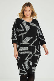 Model Jess wearing size 12 of the Belle Abstract Warm Knit Dress in colour Abstract (Black), from the front, cropped image