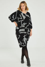 Model Jess wearing size 12 of the Belle Abstract Warm Knit Dress in colour Abstract (Black), from the front, showing the whole outfit