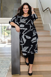 Model Lauren wearing size 16 of the Belle Abstract Warm Knit Dress in colour Abstract (Black), from the front, showing the whole outfit