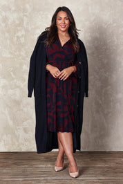 Model Ashleigh wearing size 16 of the Belle Printed Long Sleeve Mock Wrap Dress in colour Winenavy (Blue), from the front, showing the whole outfit