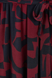 Product shot of the Belle Printed Long Sleeve Mock Wrap Dress in colour Winenavy (Blue), detail