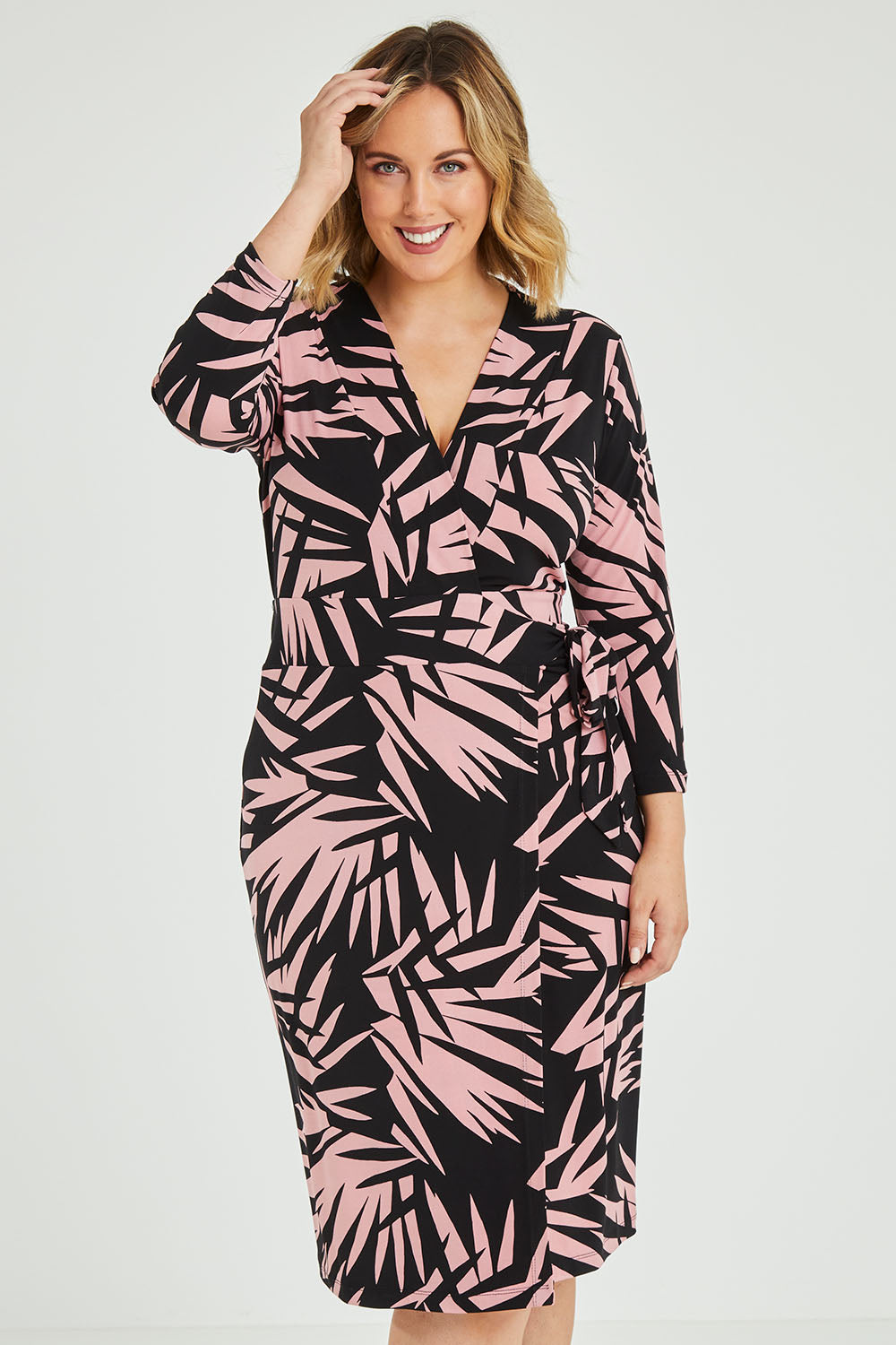 Model Jess wearing size 12 of the Belle Jungle Print Wrap Dress in colour Jungle (Black), from the front, cropped image