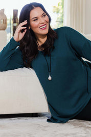 Model Lauren wearing size 16 of the Belle Winter Warm Knit Throw Over in colour Teal (Blue), from the front, showing the whole outfit