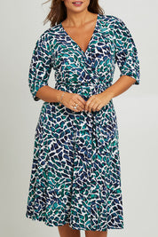 Model Monique wearing size 14 of the Belle X Over Full Skirt Dress in colour Bluegreen (Blue), from the front, cropped image