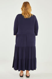 Model Caitlin wearing size 20 of the Belle Tiered Jersey Maxi Dress in colour Navy (Blue), from the back