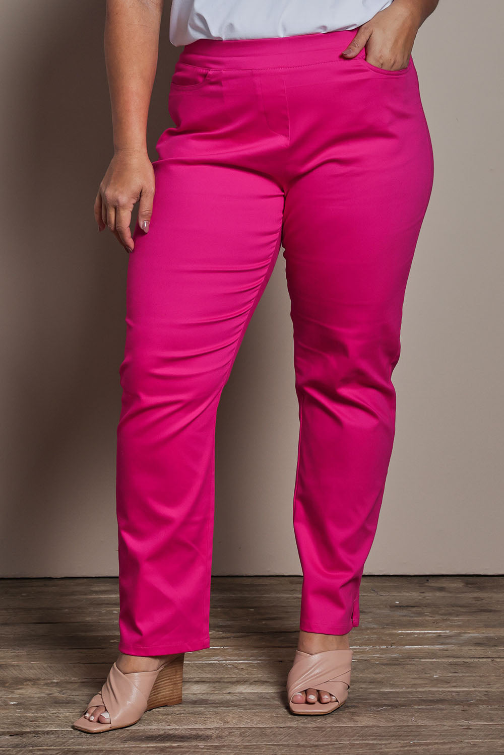 Model Ashleigh wearing size 16 of the Belle Pull On Slim Leg Cotton Stretch  Pant in colour Fuschia (Pink), from the front, cropped image