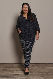Model Ashleigh wearing size 16 of the Belle Printed Pull On Slim Leg Cotton Stretch  Pant in colour Blackwhite (Black), from the front, showing the whole outfit