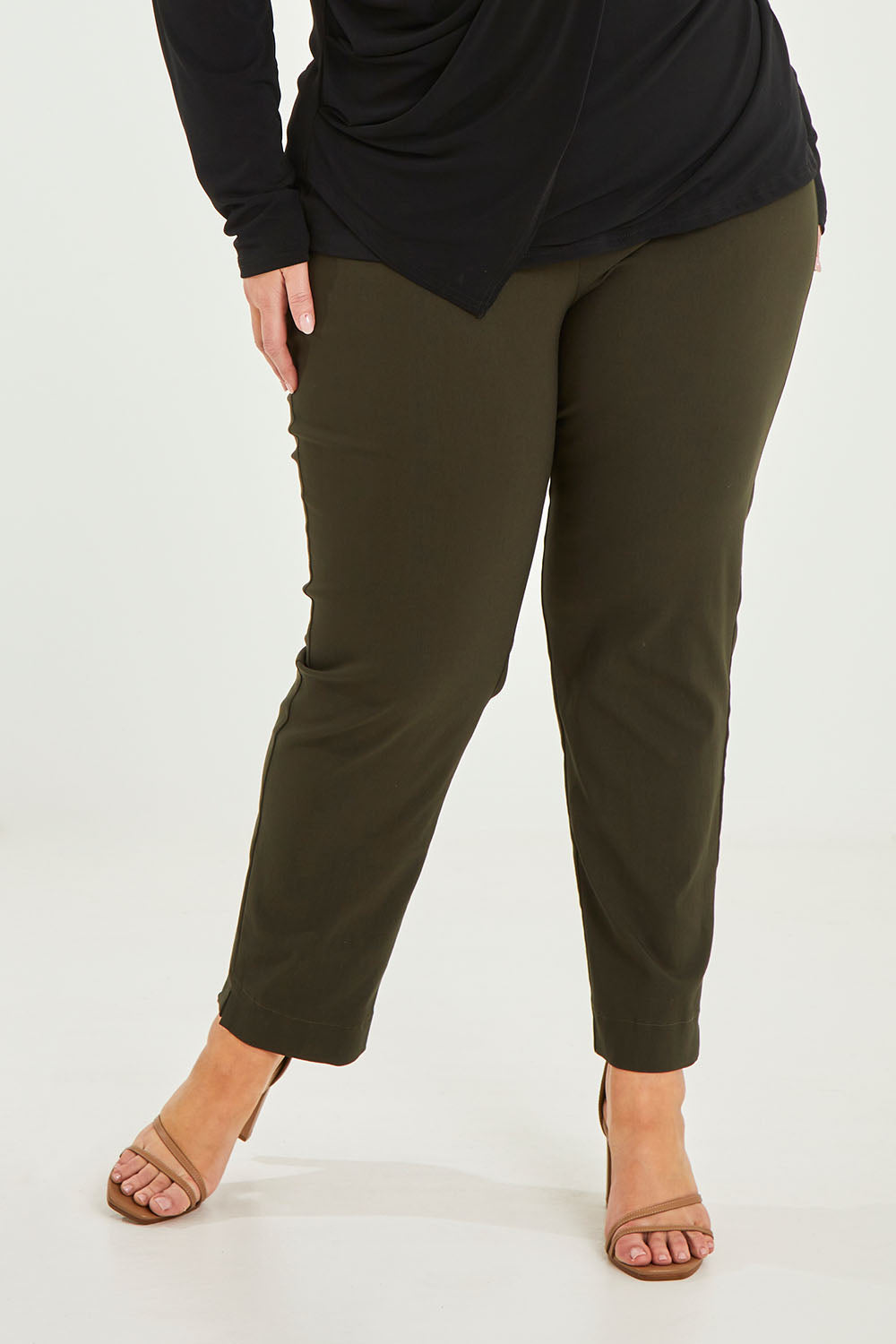 Model Caitlin wearing size 20 of the Belle Essential Pull On Slim Leg Pant in colour Nightgreen (Green), from the front, cropped image