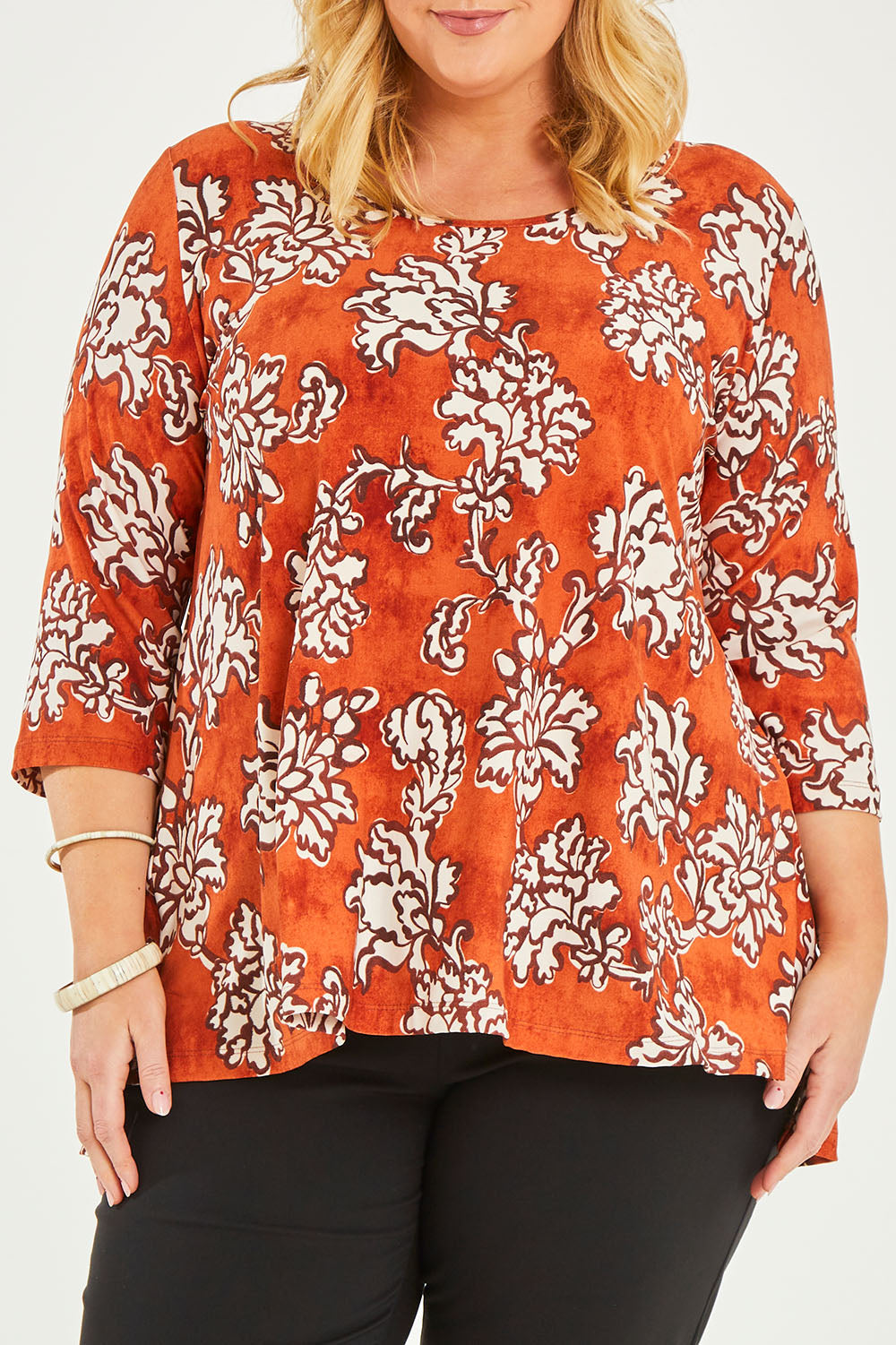 Model Caitlin wearing size 20 of the Belle High Low Tee Shirt in colour Rustfloral, from the front, cropped image