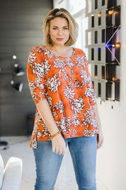 Model Fiona wearing size 10 of the Belle High Low Tee Shirt in colour Rustfloral, from the front, showing the whole outfit