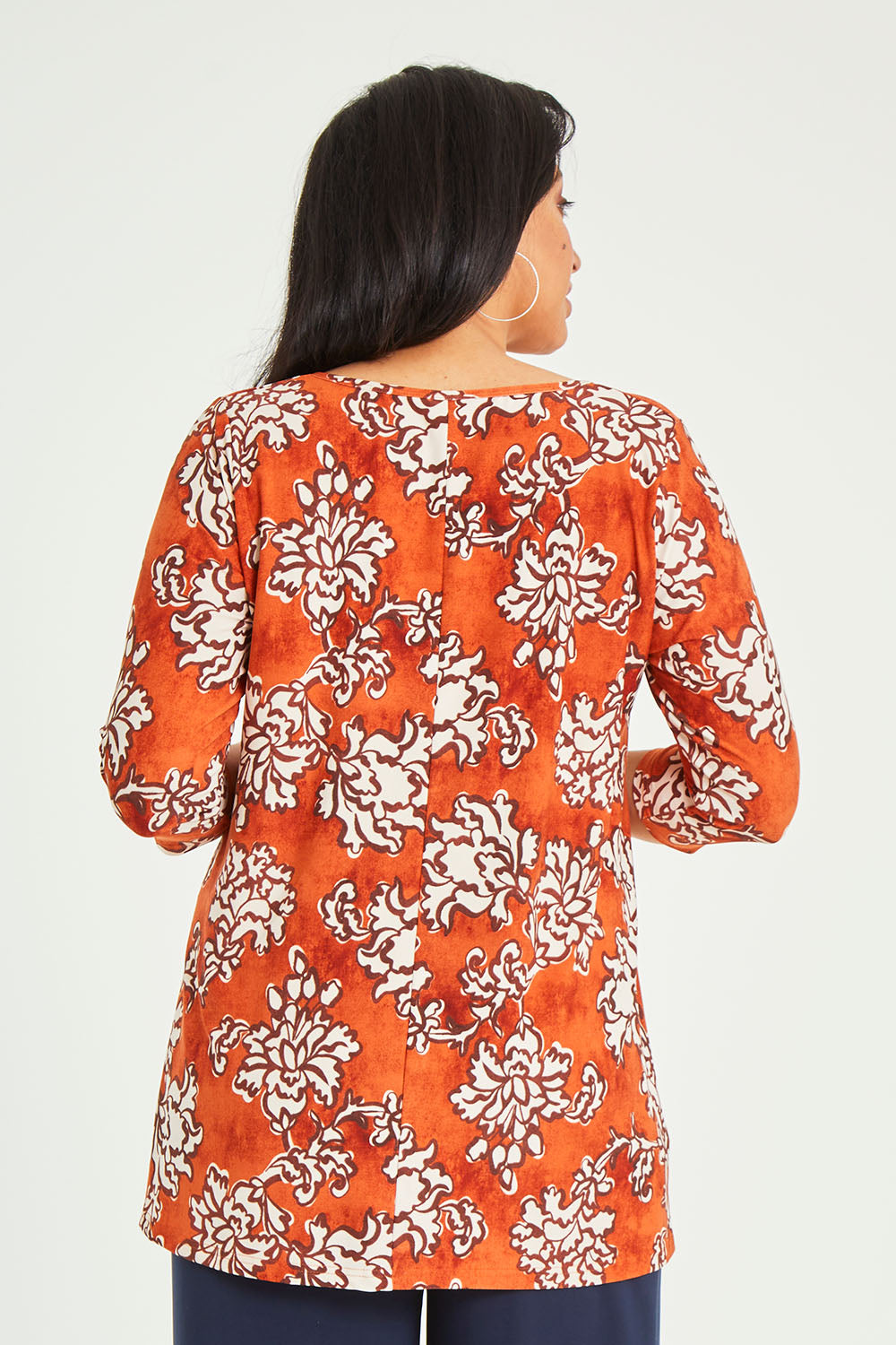 Model Terri-Leigh wearing size 14 of the Belle High Low Tee Shirt in colour Rustfloral, from the back