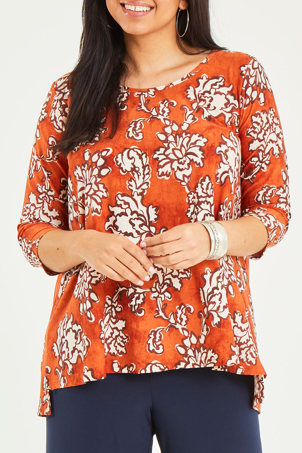 Model Terri-Leigh wearing size 14 of the Belle High Low Tee Shirt in colour Rustfloral, from the front, cropped image