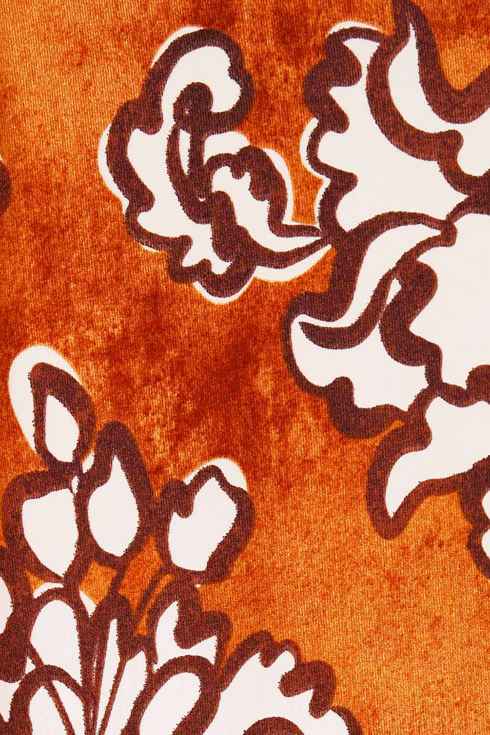 Product shot of the Belle High Low Tee Shirt in colour Rustfloral, detail