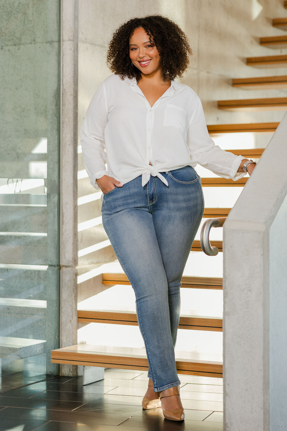 Model Alexis wearing size 18 of the Belle Boot Leg Jean in colour Mediumblue (Blue), from the front, showing the whole outfit