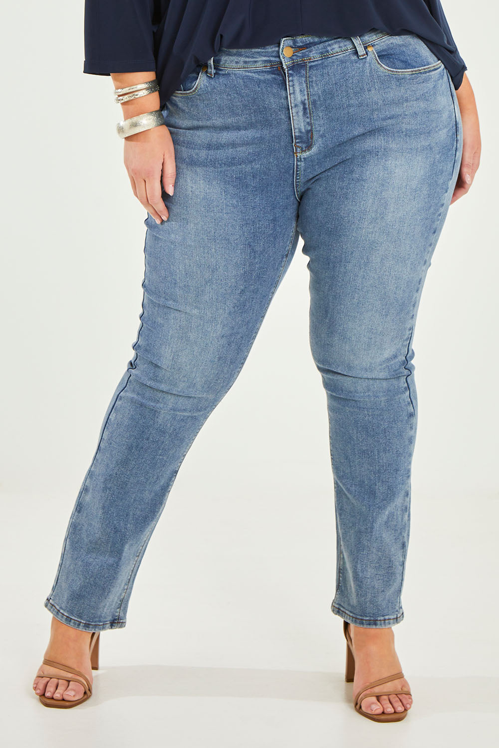 Model Caitlin wearing size 20 of the Belle Boot Leg Jean in colour Mediumblue (Blue), from the front, cropped image