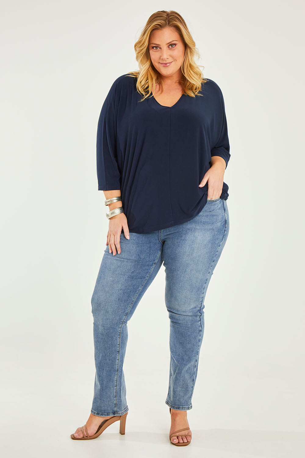 Model Caitlin wearing size 20 of the Belle Boot Leg Jean in colour Mediumblue (Blue), from the front, showing the whole outfit