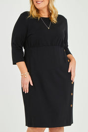 Model Caitlin wearing size 20 of the Belle Ponte Everywear Dress in colour Black (Black), from the front, cropped image