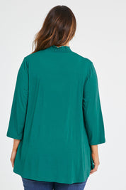 Model Laura wearing size 14 of the Belle Turtleneck Draped Bamboo Tee in colour Teal (Green), from the back