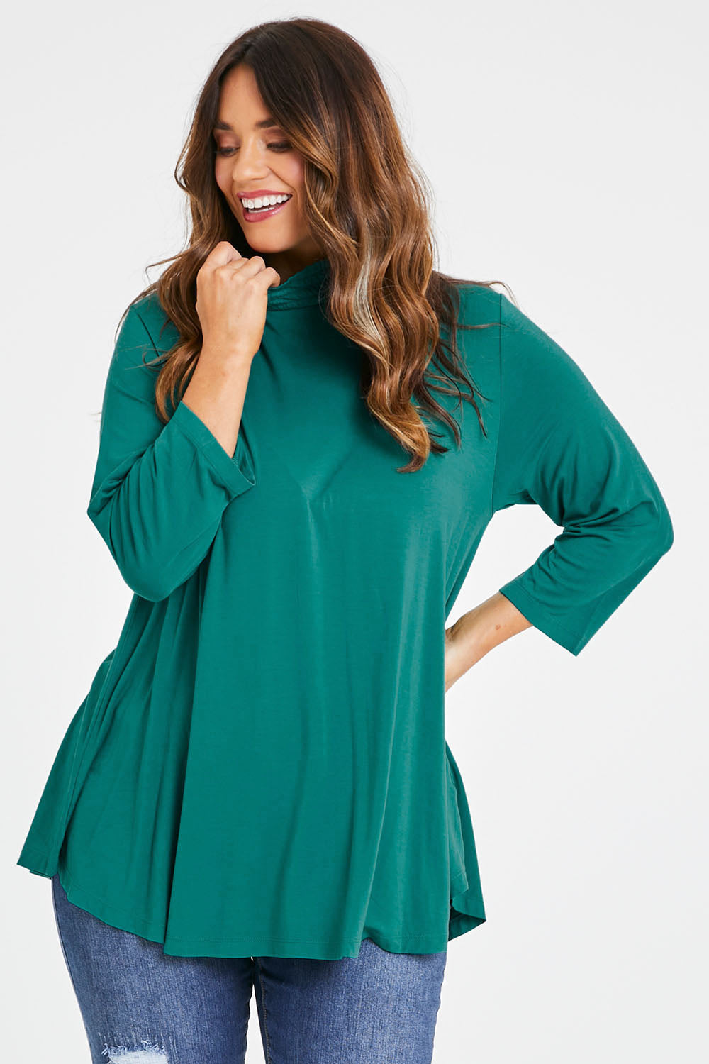 Model Laura wearing size 14 of the Belle Turtleneck Draped Bamboo Tee in colour Teal (Green), from the front, cropped image