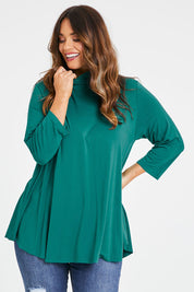 Model Laura wearing size 14 of the Belle Turtleneck Draped Bamboo Tee in colour Teal (Green), from the front, cropped image