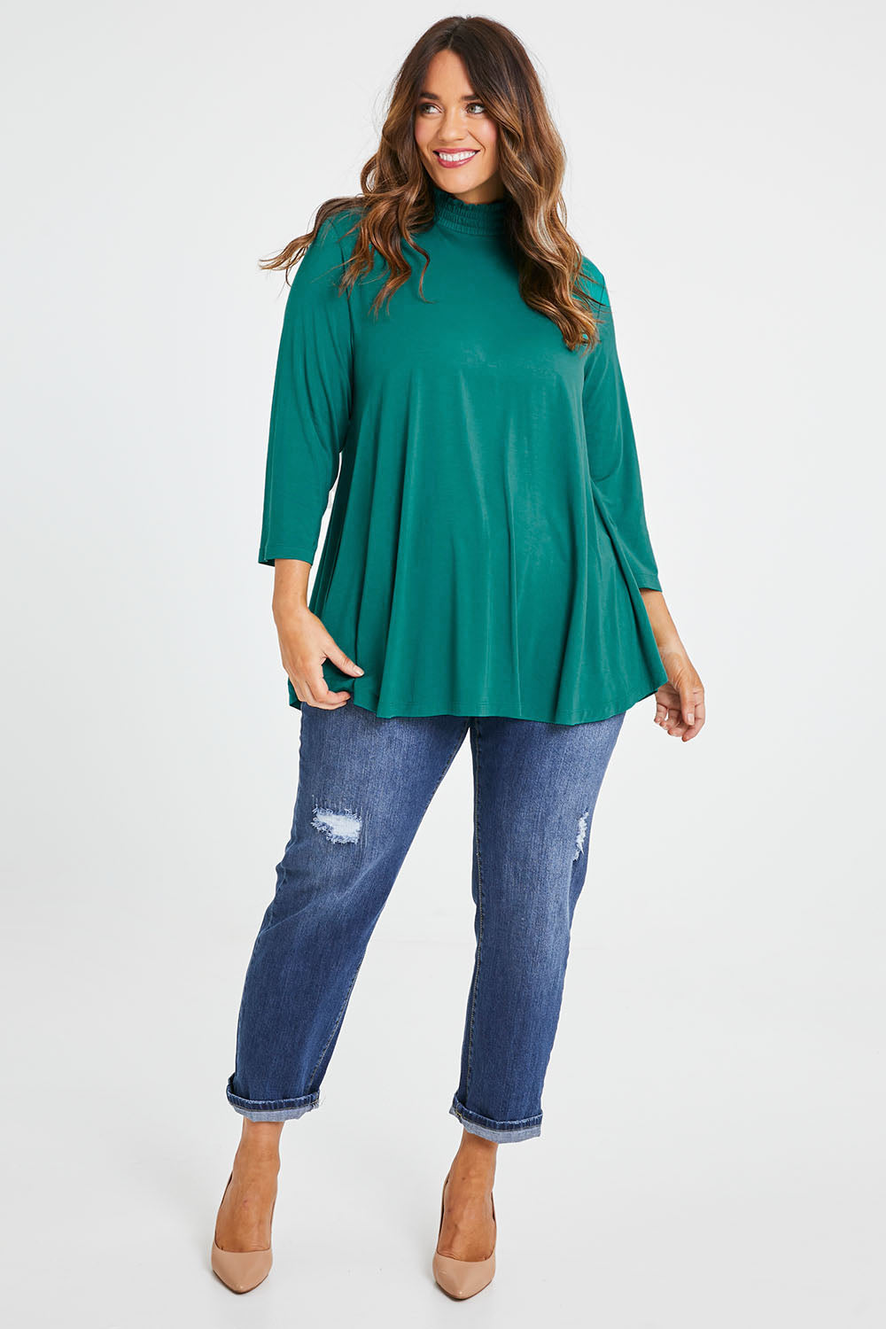 Model Laura wearing size 14 of the Belle Turtleneck Draped Bamboo Tee in colour Teal (Green), from the front, showing the whole outfit