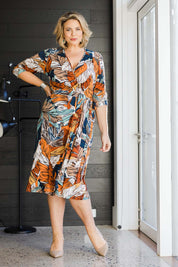 Model Fiona wearing size 16 of the Belle Faux Long Sleeve Wrap Dress in colour Leafprint (White), from the front, showing the whole outfit