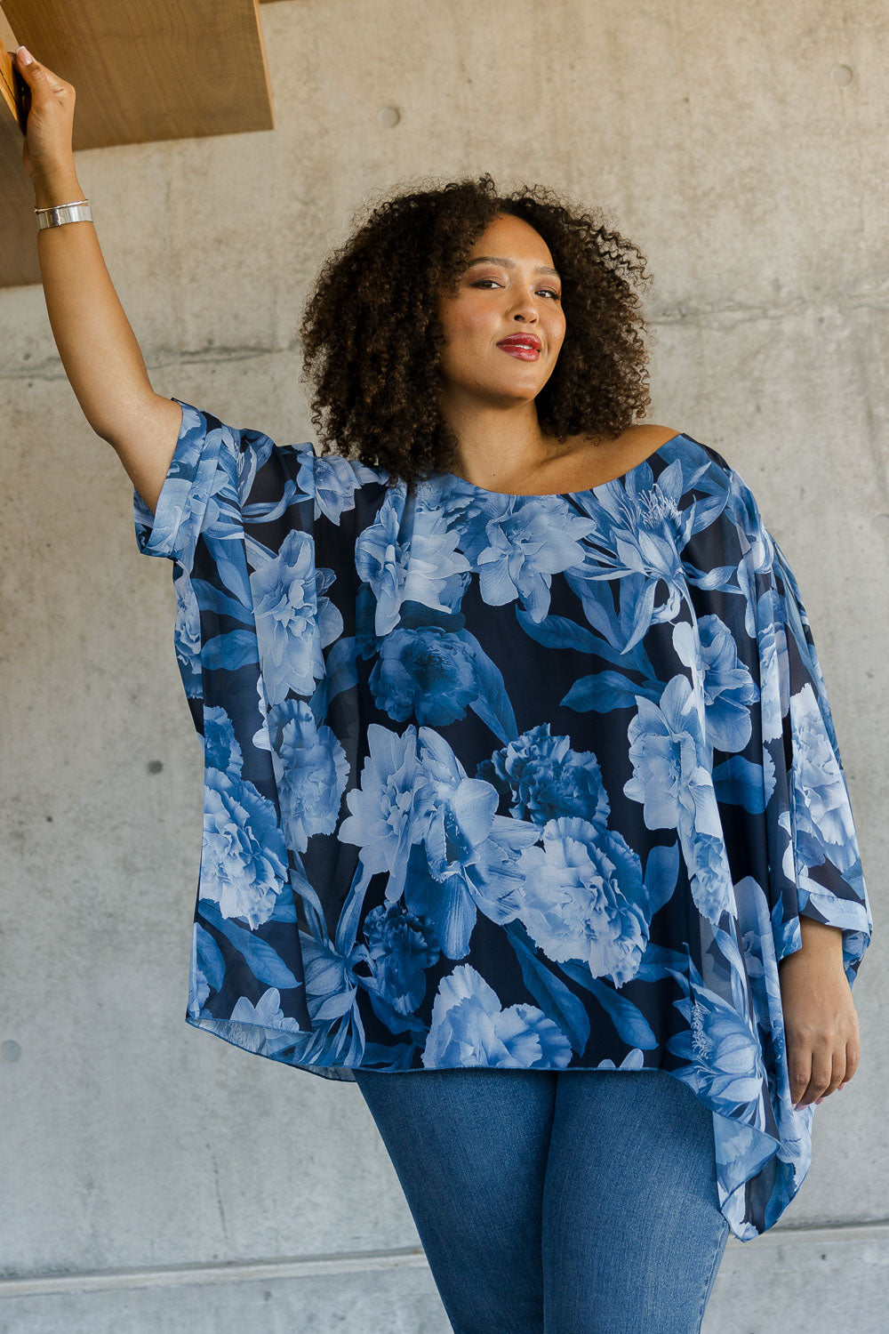 Model Alexis wearing size 18 of the Belle Chiffon Overlay Top in colour Bluefloral (Blue), from the front, showing the whole outfit