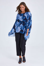 Model Monique wearing size 14 of the Belle Chiffon Overlay Top in colour Bluefloral (Blue), from the front, showing the whole outfit