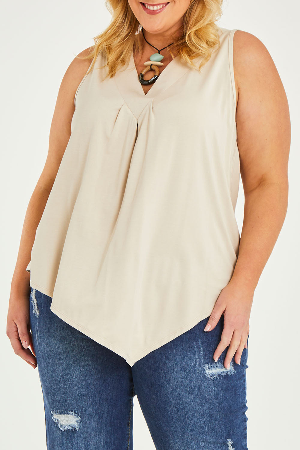 Model Caitlin wearing size 20 of the Belle Asymmetric Luxe Bamboo Tank in colour Straw, from the front, cropped image