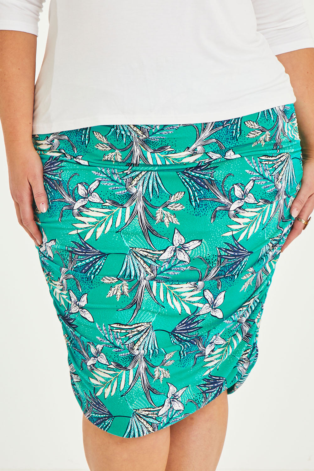 Model Caitlin wearing size 20 of the Belle Lined Side Gathered Skirt in colour Aquafleur (Green), from the front, cropped image