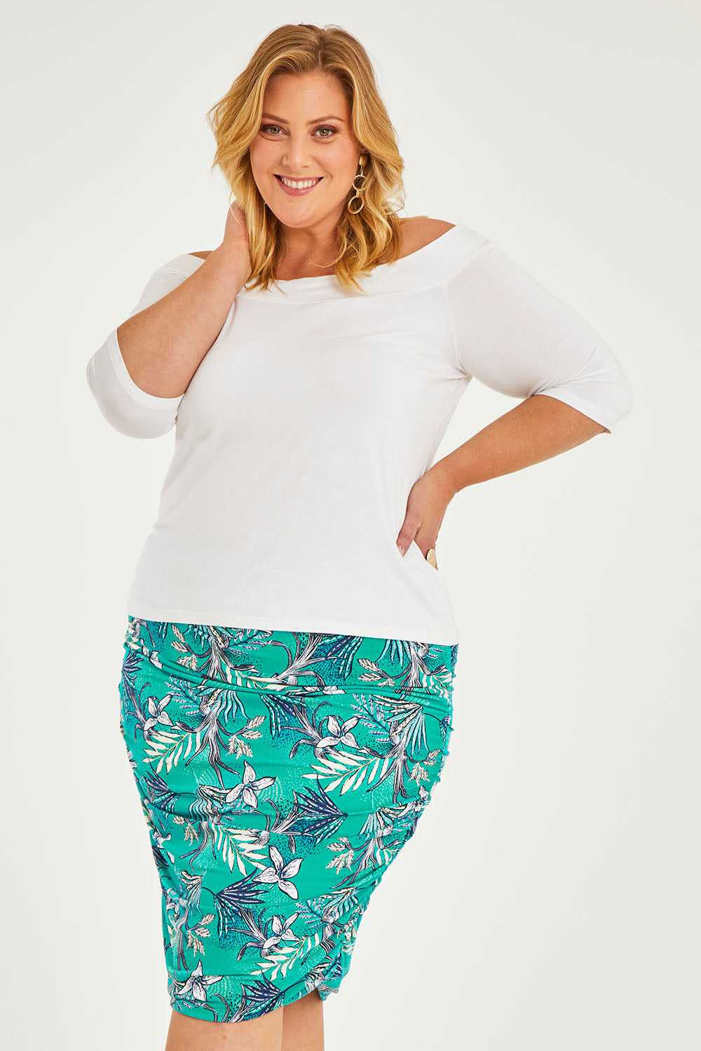 Model Caitlin wearing size 20 of the Belle Lined Side Gathered Skirt in colour Aquafleur (Green), from the front, cropped image