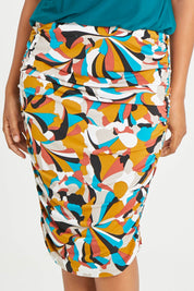 Model Noli wearing size 14 of the Belle Lined Side Gathered Skirt in colour Multiprint, from the front, cropped image