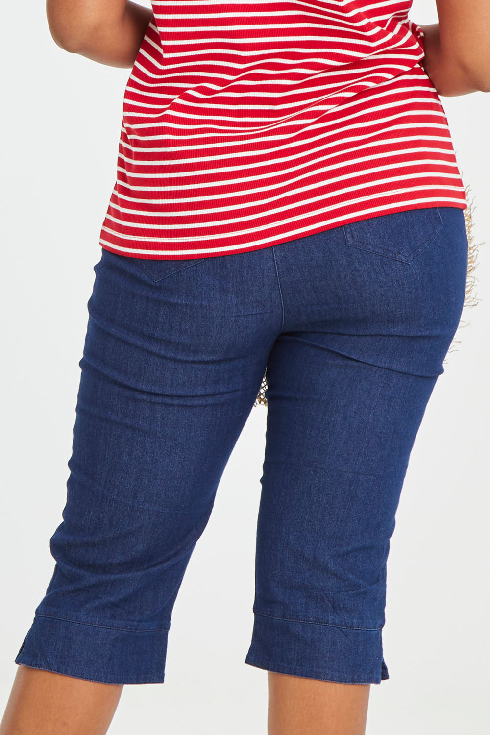 Model Noli wearing size 14 of the Belle 3/4 Length Pull On Jean in colour Denim (Blue), from the back